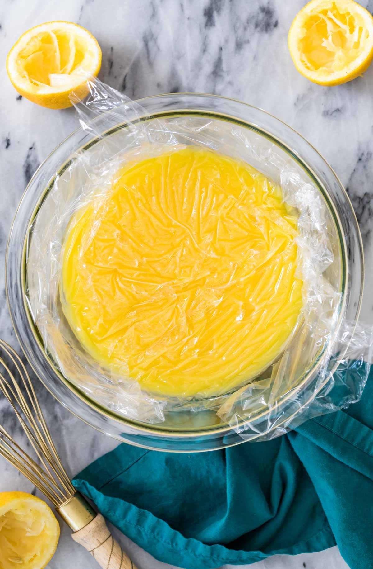 clear glass bowl covered with plastic wrap to prevent a skin from forming on the contents of the bowl