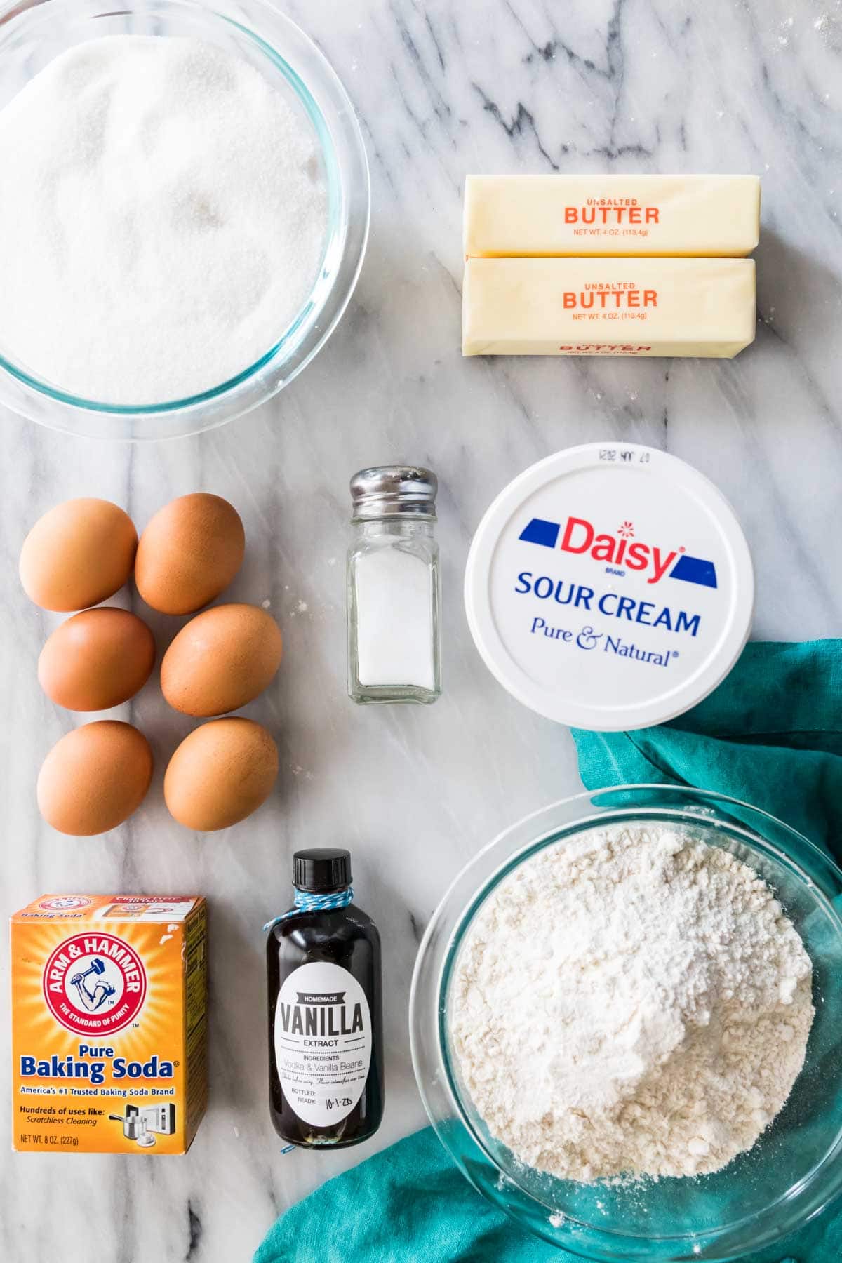 overhead view of ingredients including eggs, butter, sour cream, flour, and more