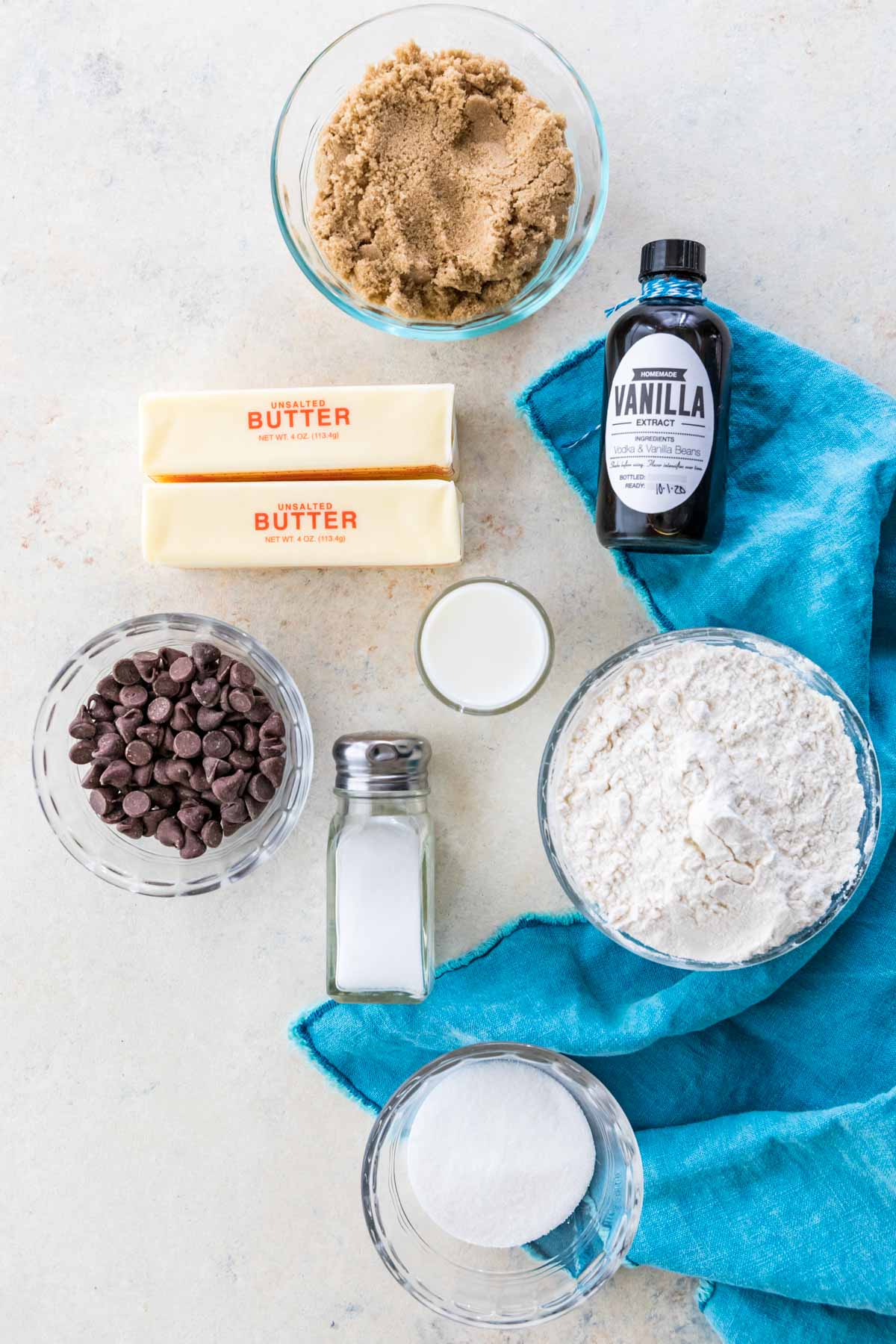 overhead view of ingredients including brown sugar, butter, vanilla, chocolate chips, and more