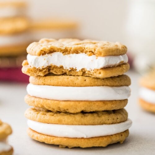 three stacked fluffernutter cookies, with the top cookie missing a bite