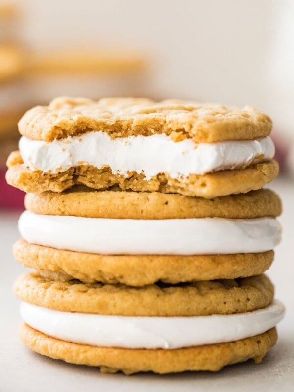 three stacked fluffernutter cookies, with the top cookie missing a bite