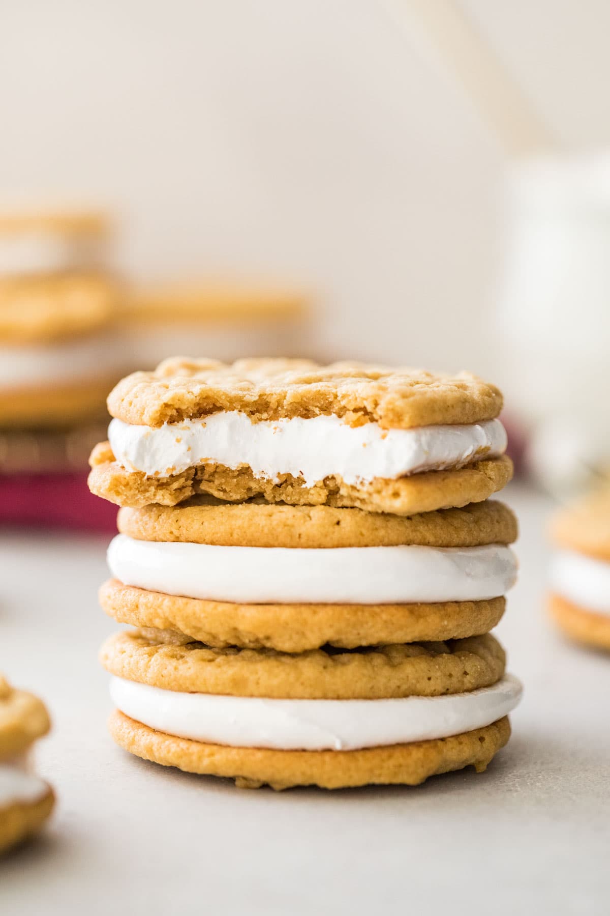 three stacked fluffernutter cookies, with the top cookie missing a bite