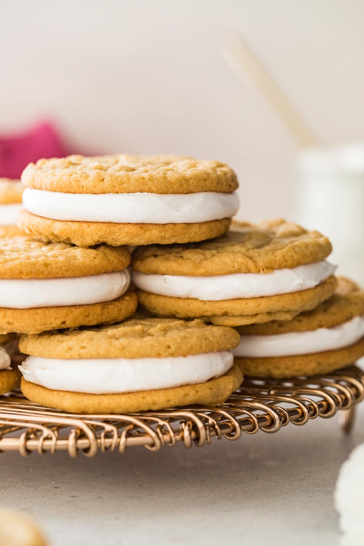 pile of peanut butter marshmallow sandwich cookies stacked on a metal cooling rack