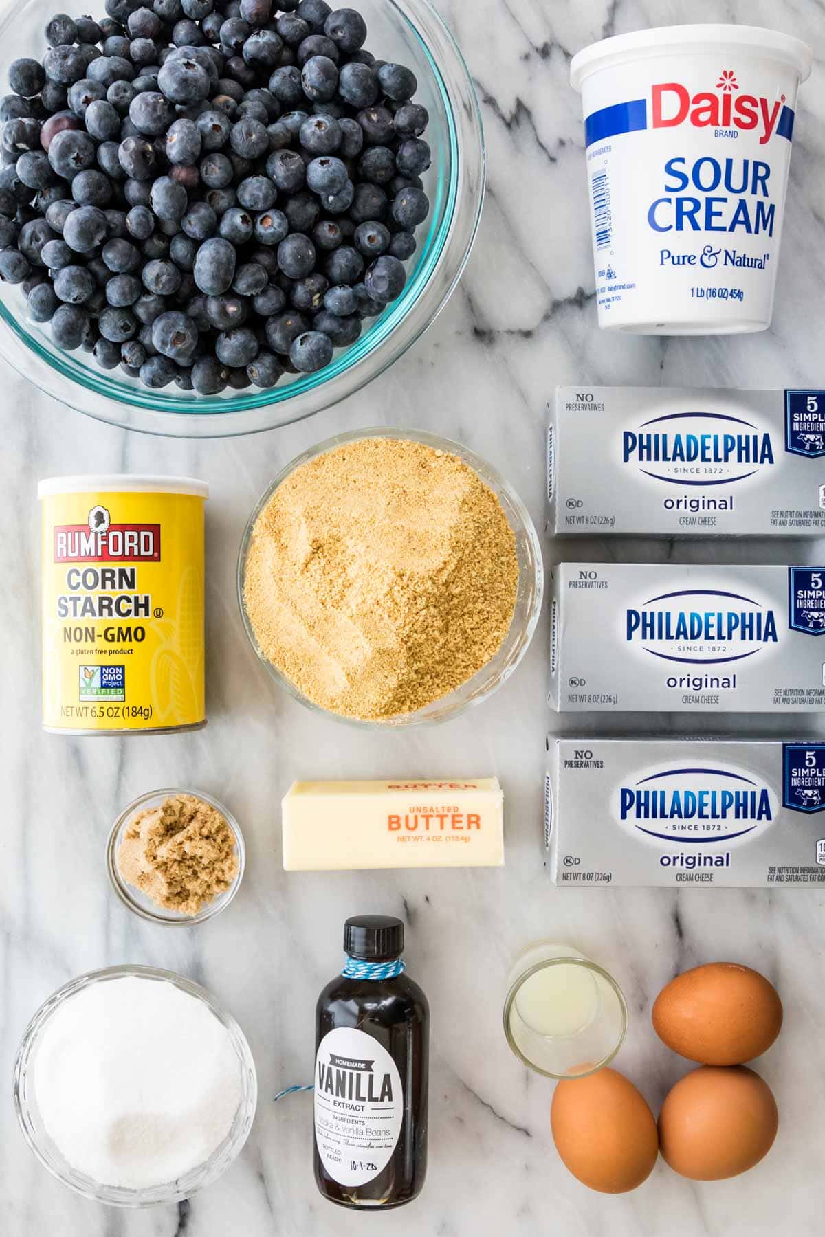 overhead view of ingredients including blueberries, sour cream, cream cheese and more