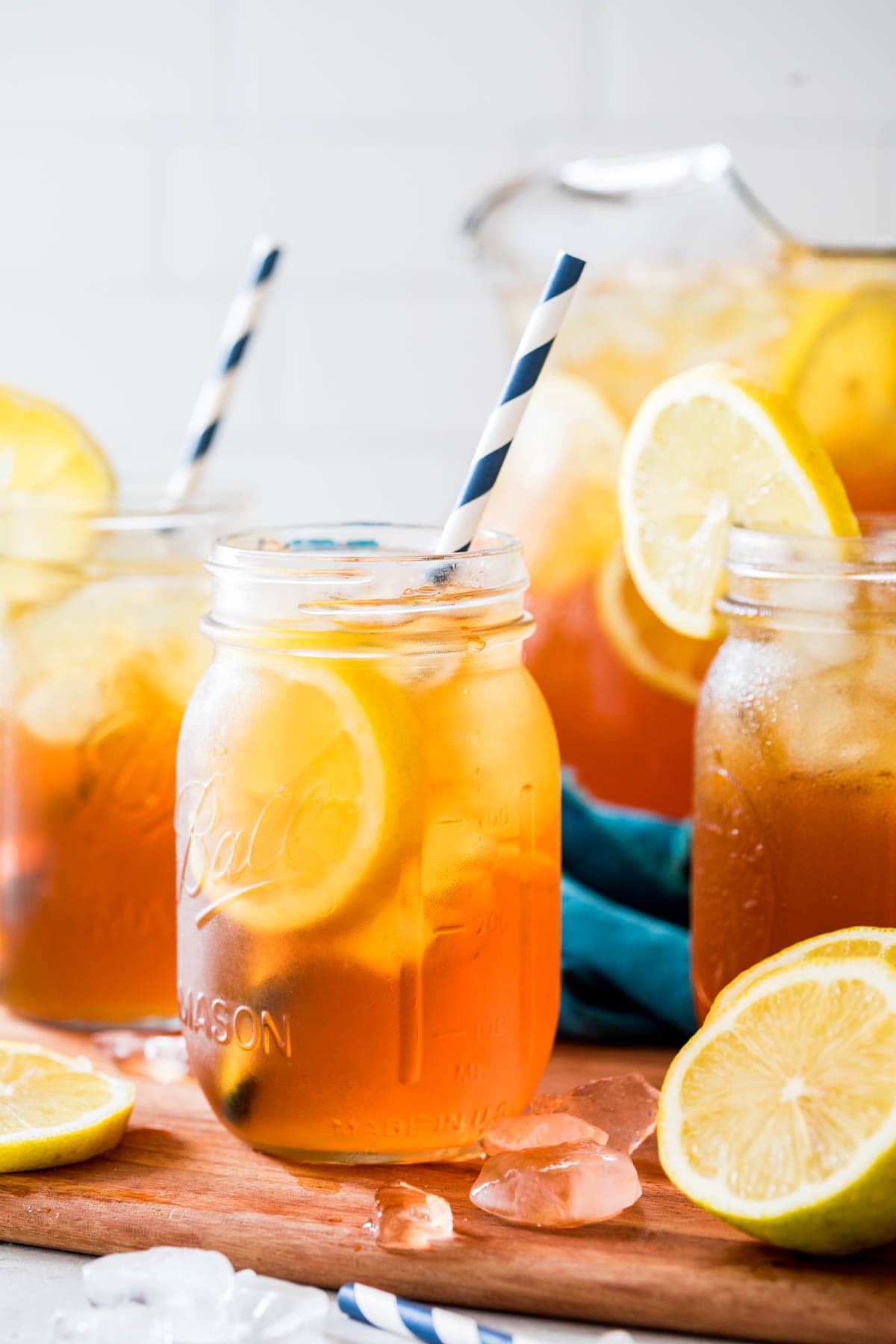 mason jars of iced tea with striped paper straws