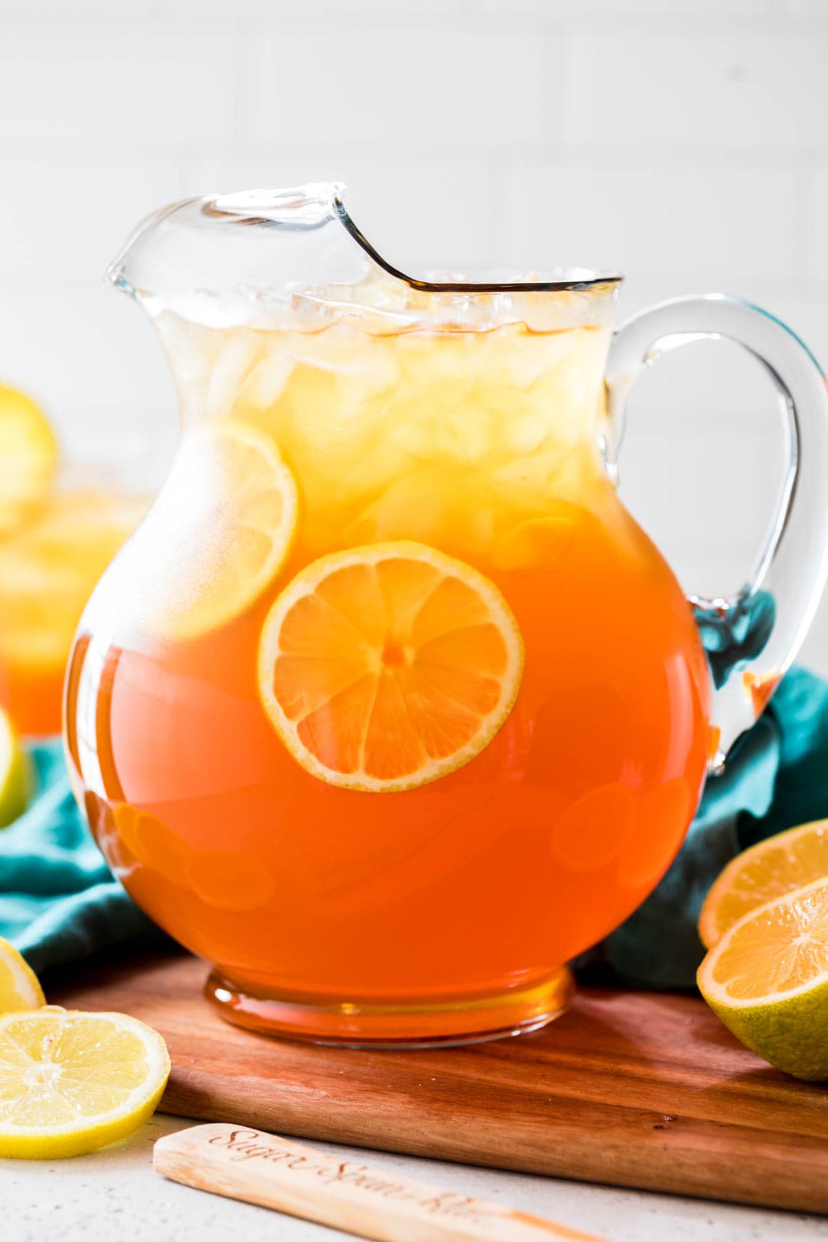 large glass pitcher of iced tea with lemon rounds