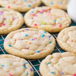 sprinkle-flecked funfetti cookies cooling on a cooling rack