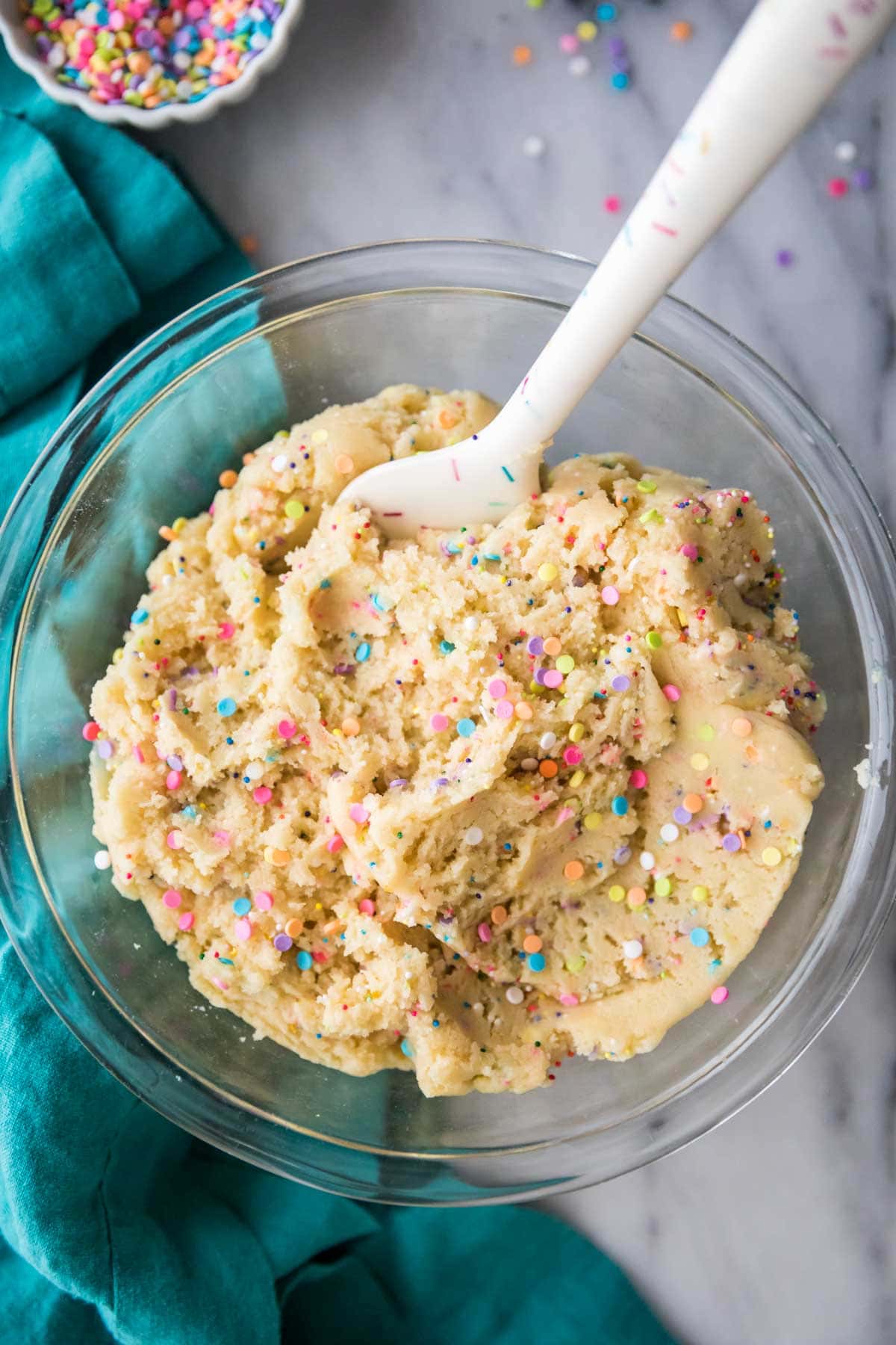 overhead view of cookie dough that's been sprinkled with rainbow jimmies