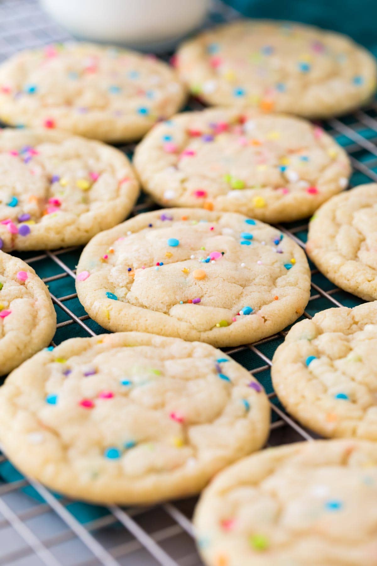 sprinkle-flecked funfetti cookies cooling on a cooling rack