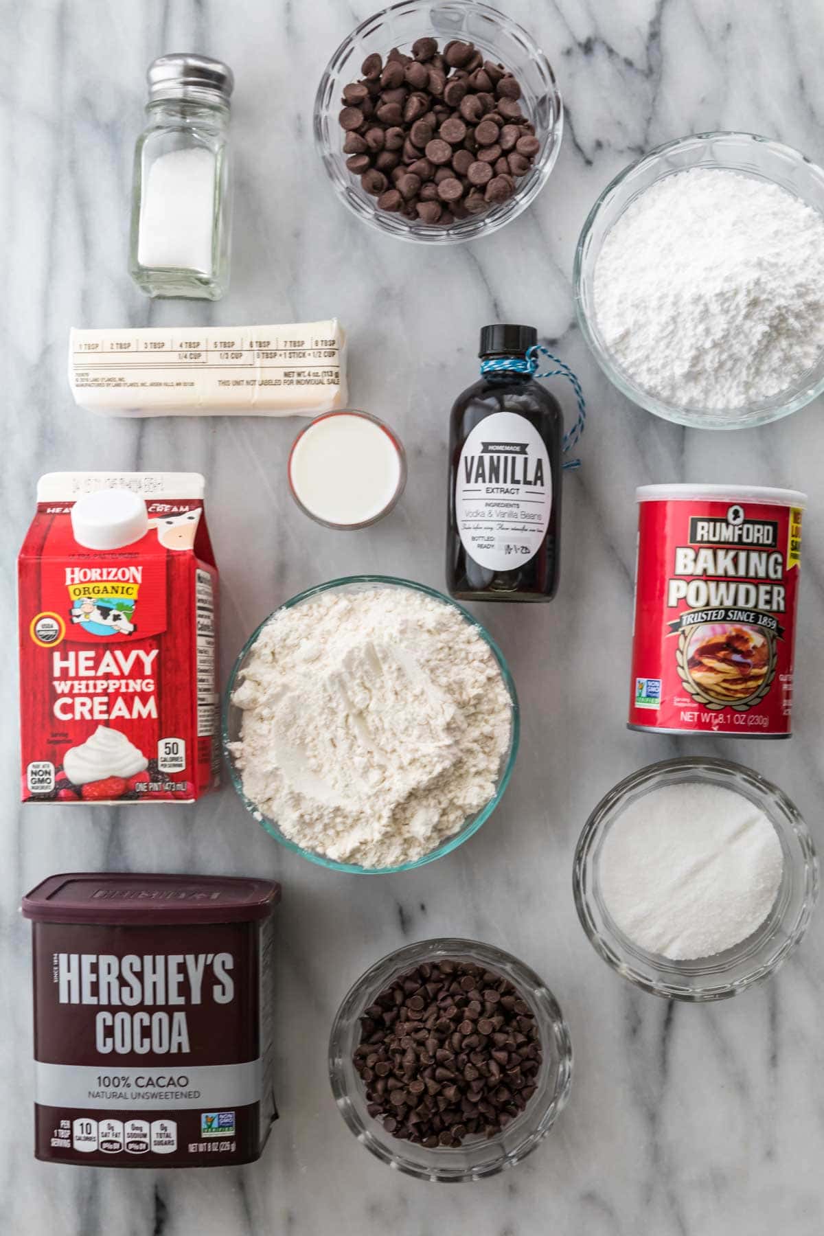 overhead view of ingredients including cream, flour, cocoa powder, chocolate chips, and more