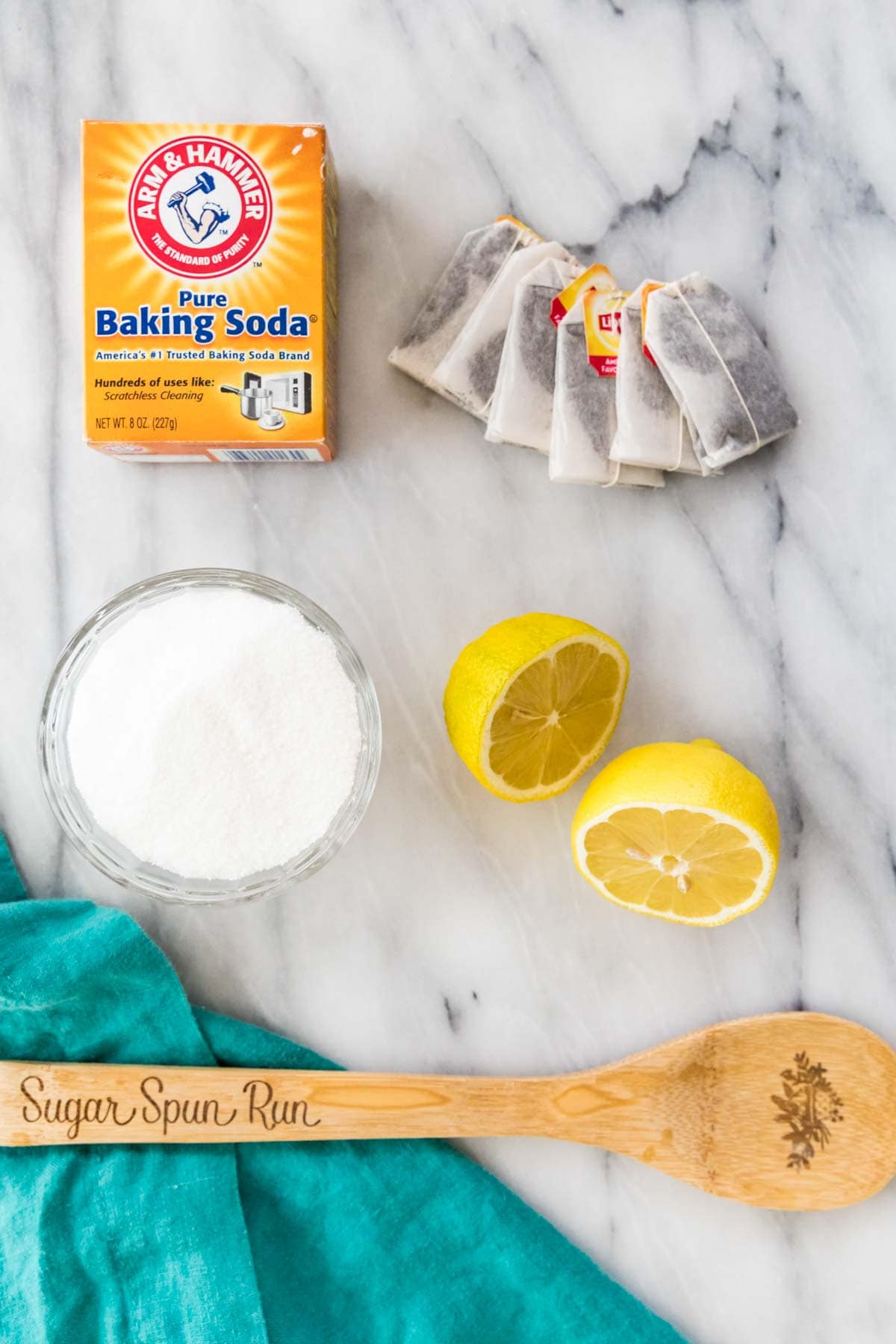 overhead view of ingredients including baking soda, tea bags, sugar, and lemons