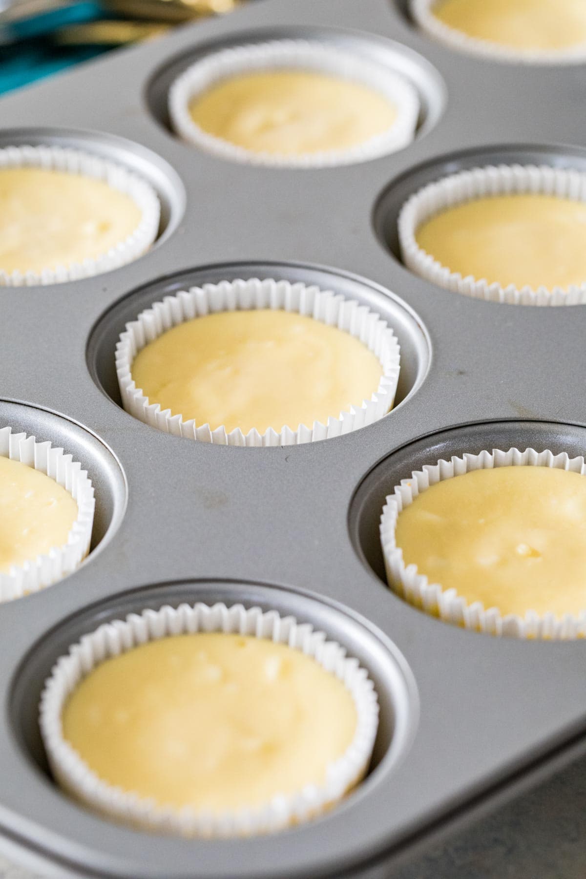 close-up view of cheesecake batter in a cupcake liners