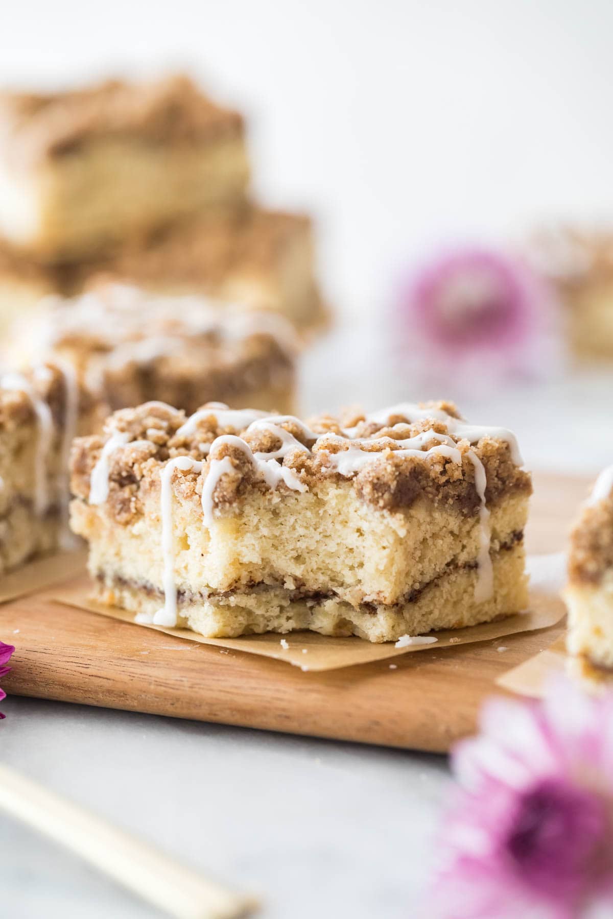 square slice of crumb topped cake missing a bite