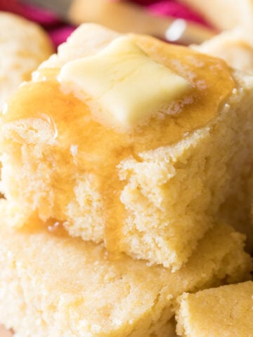 stacked squares of buttermilk cornbread topped with honey and butter