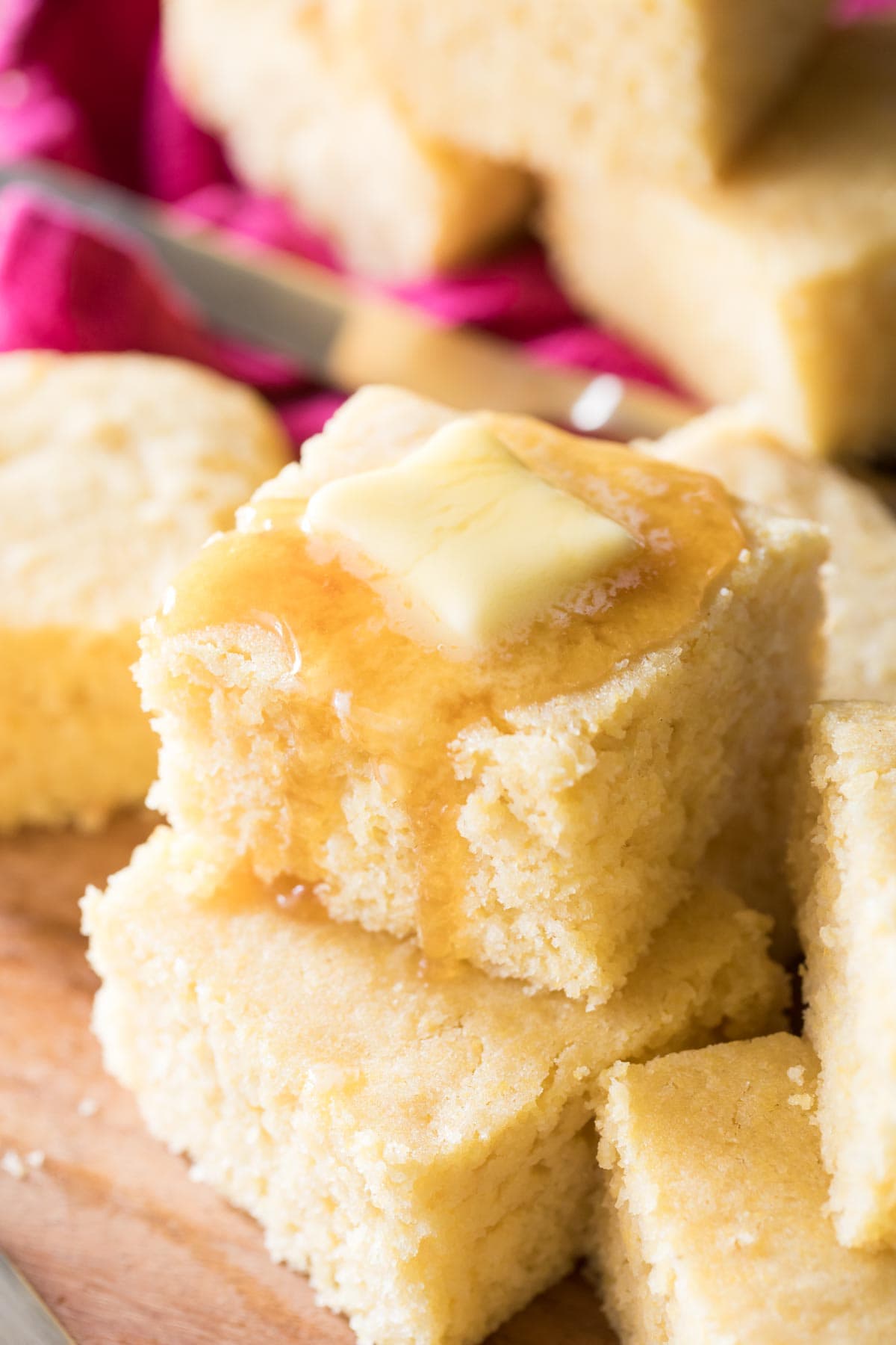 stacked squares of buttermilk cornbread topped with honey and butter