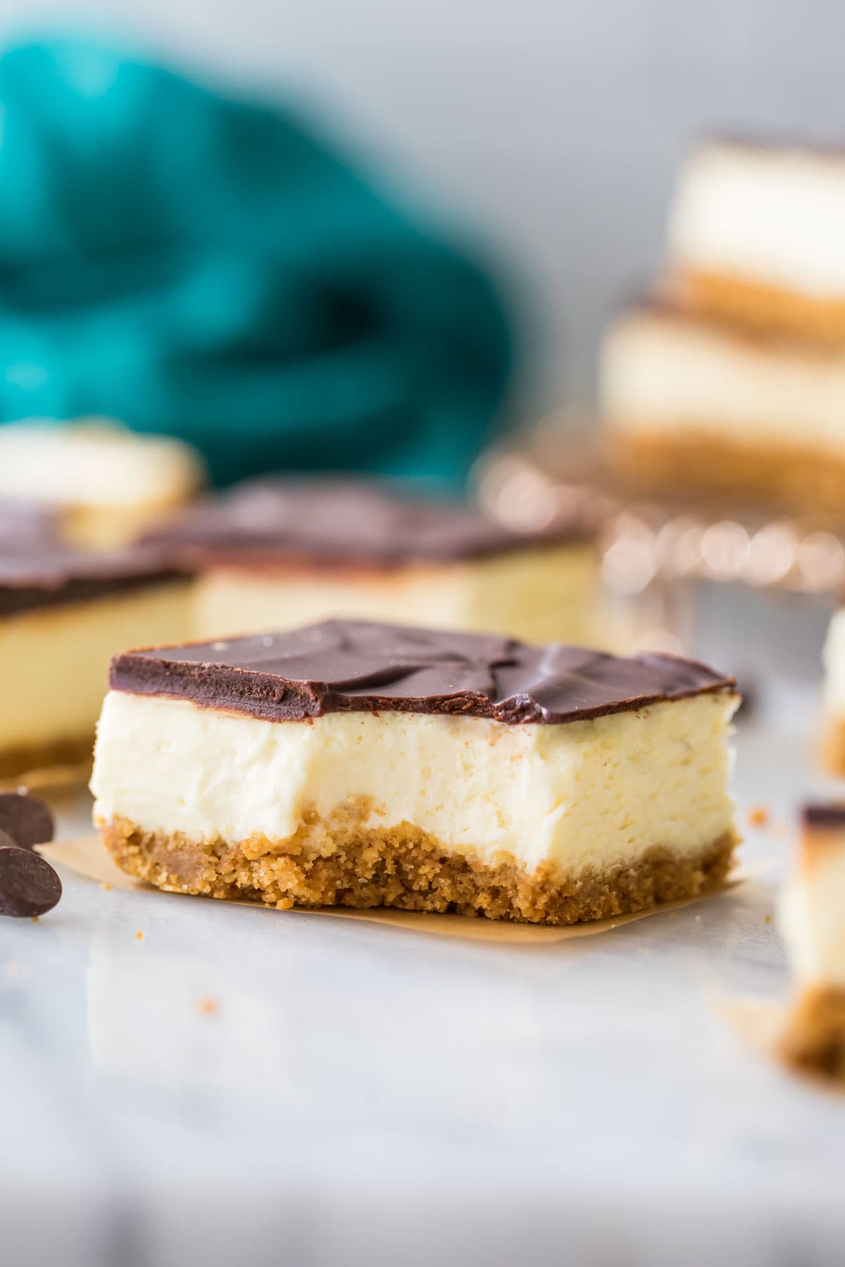 ganache-covered custard bar on a graham cracker crust missing one bite