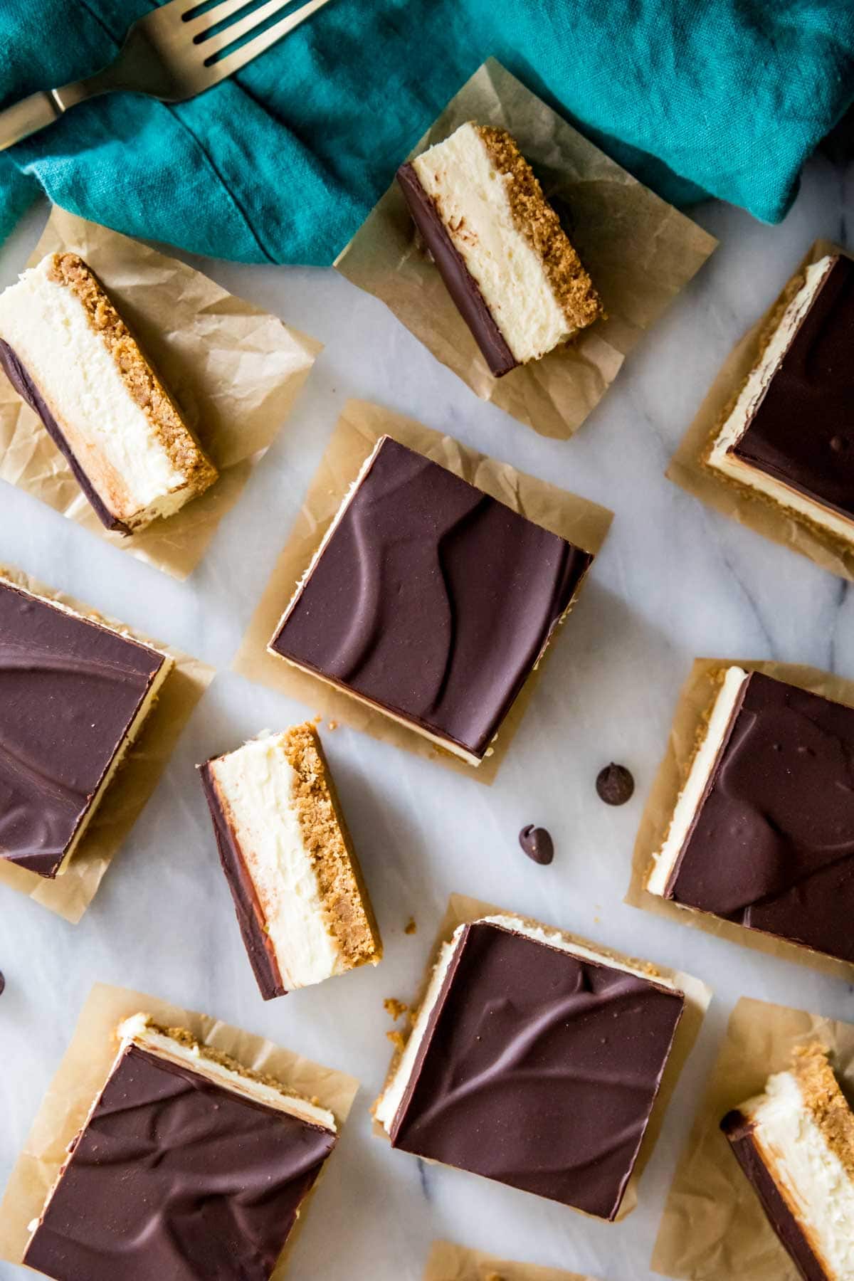 overhead view of creamy, ganache-covered bars on a graham cracker crust