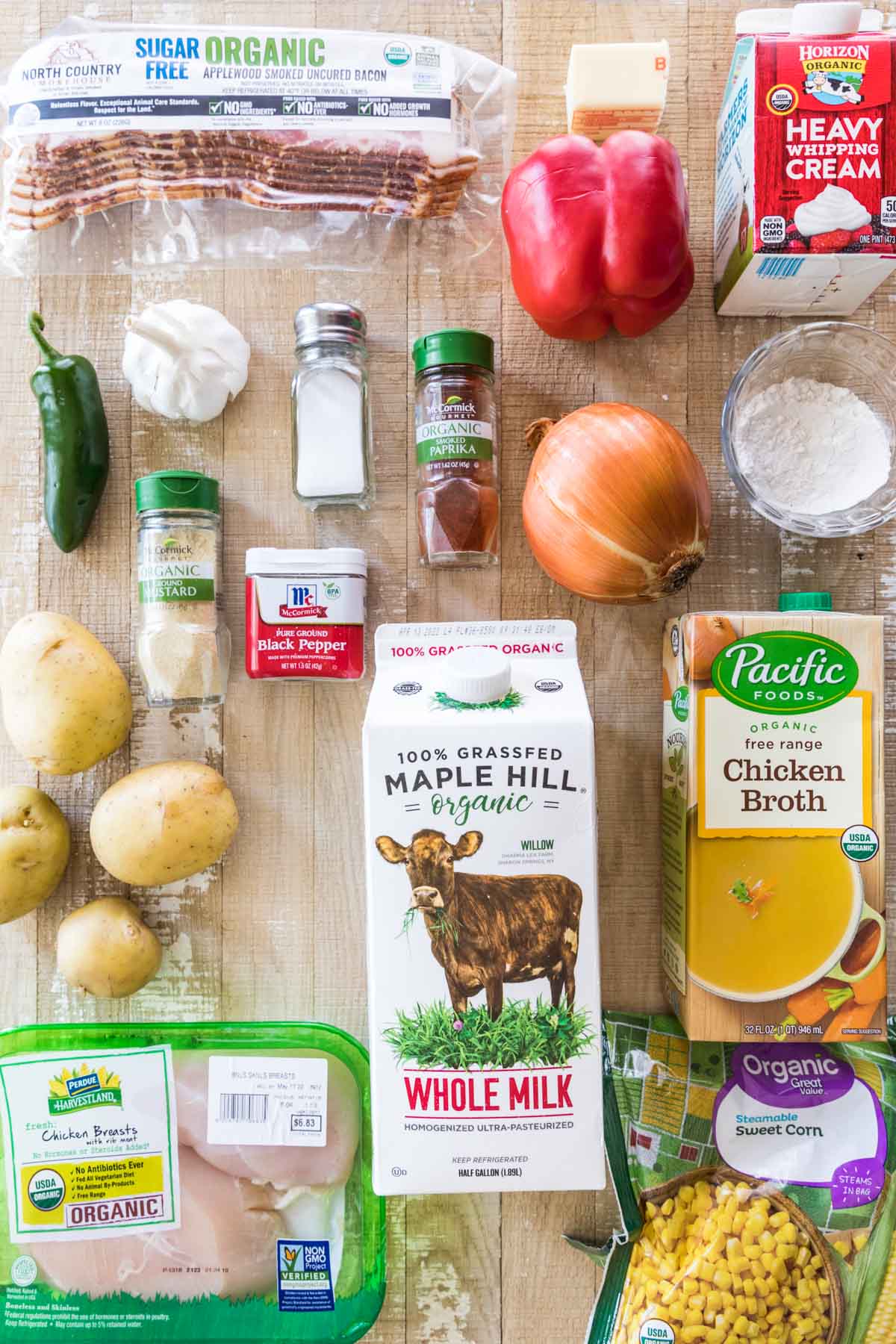 overhead view of ingredients including bacon, chicken broth, potatoes, chicken, and more