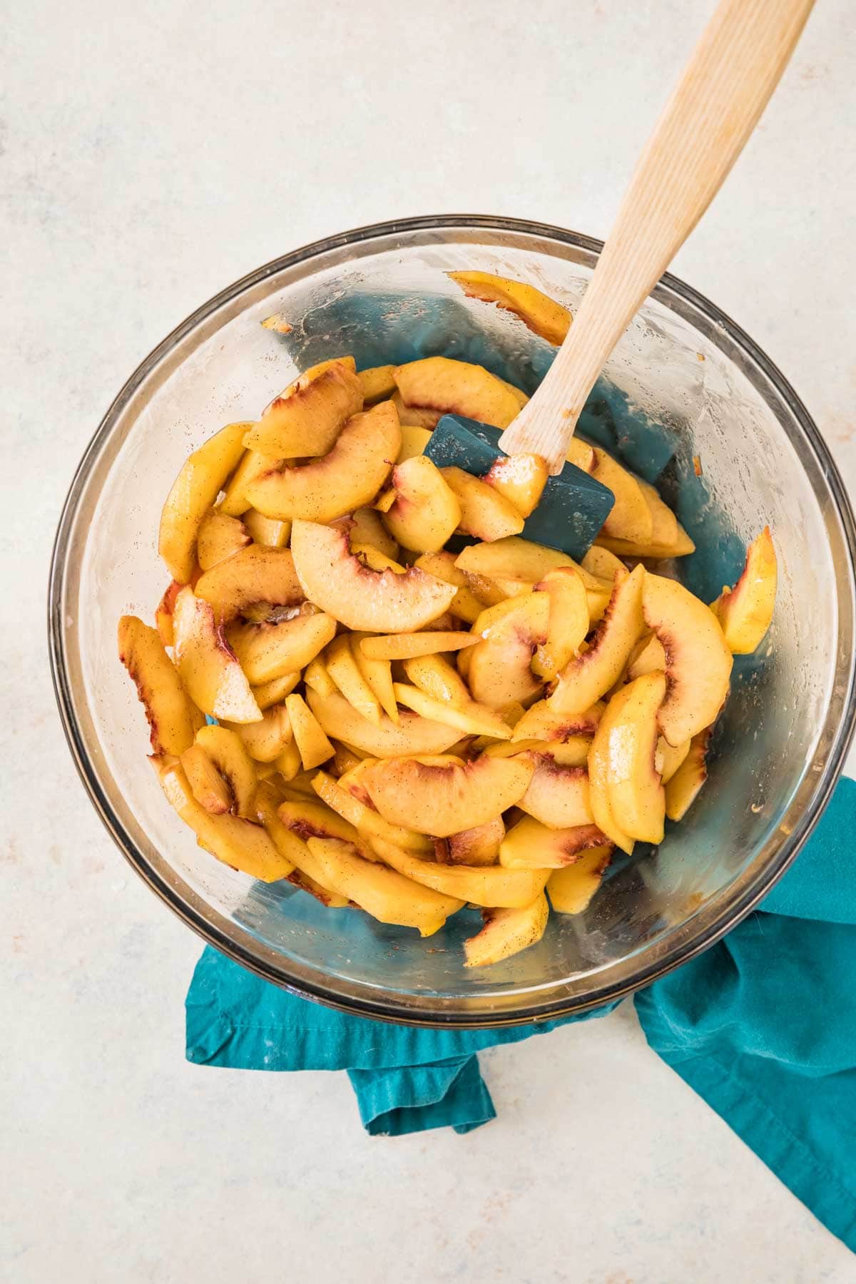 overhead view of peaches being macerated in preparation for cobbler