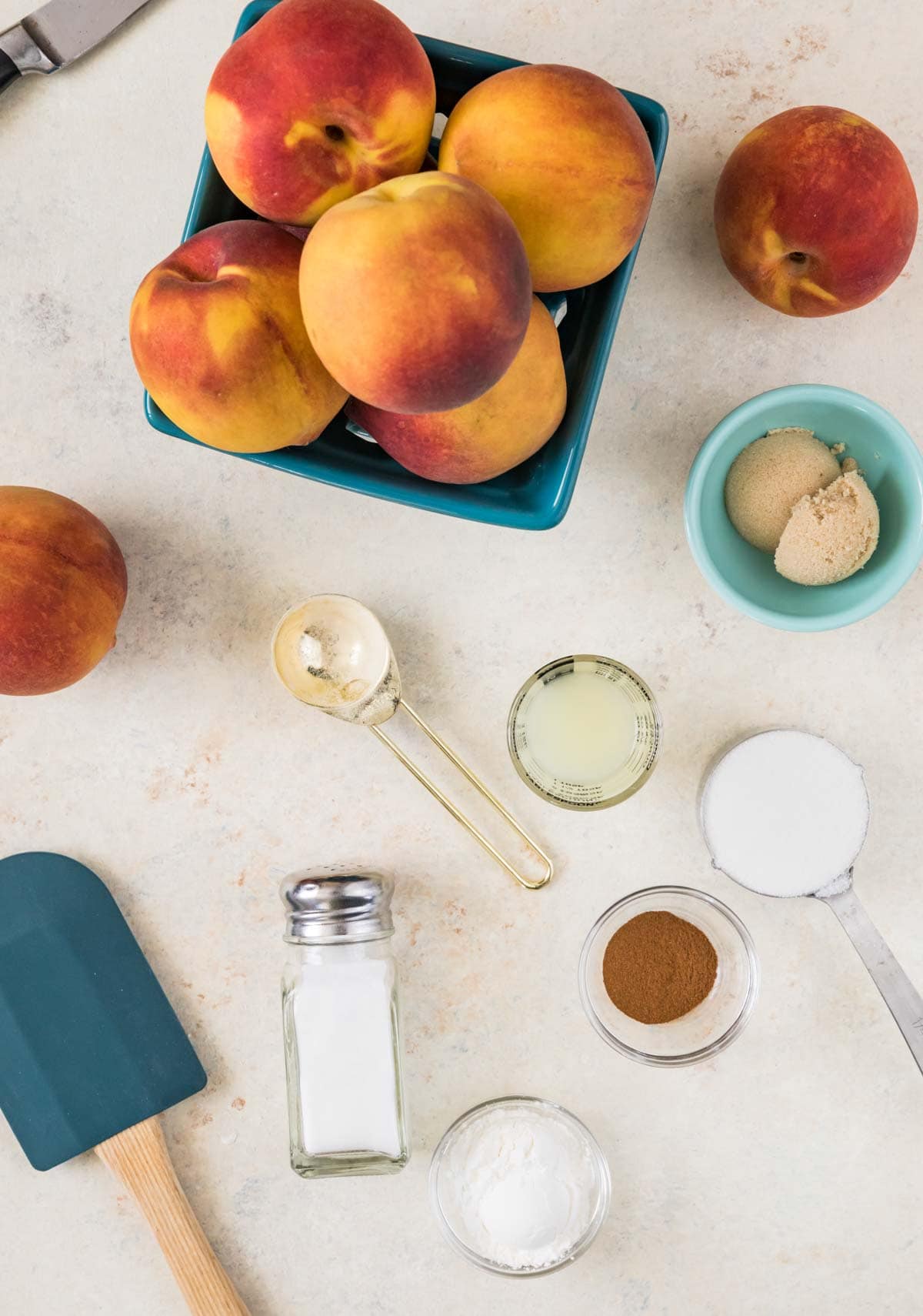 overhead view of ingredients including peaches, brown sugar, lemon juice, and more