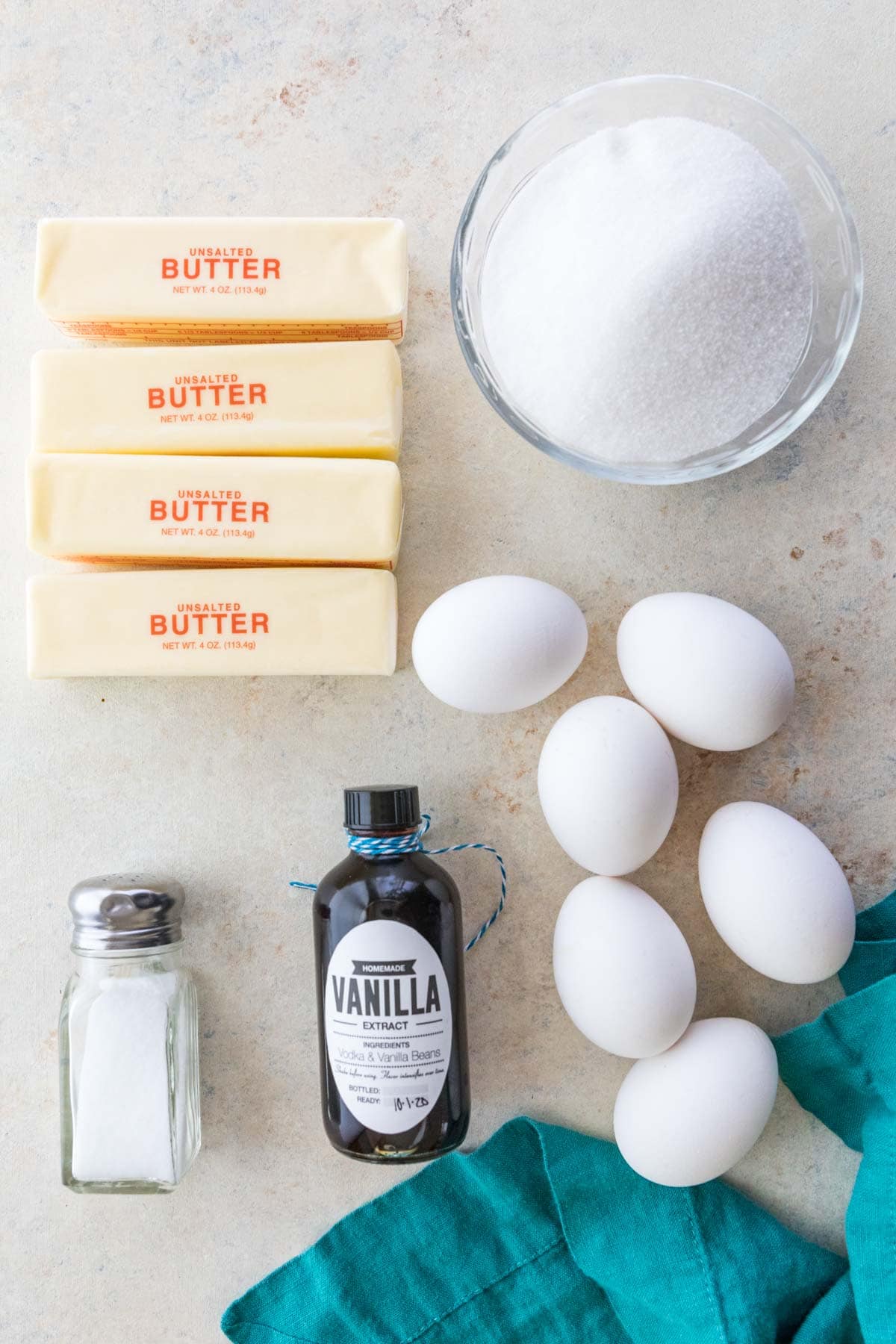 overhead view of ingredients including butter, sugar, eggs, vanilla, and salt