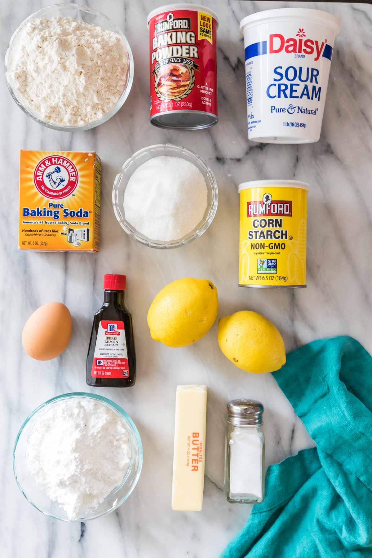 overhead view of ingredients including lemons, sour cream, flour, and more