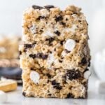 three stacked cookies and cream rice krispie treats studded with crushed oreos and mini marshmallows