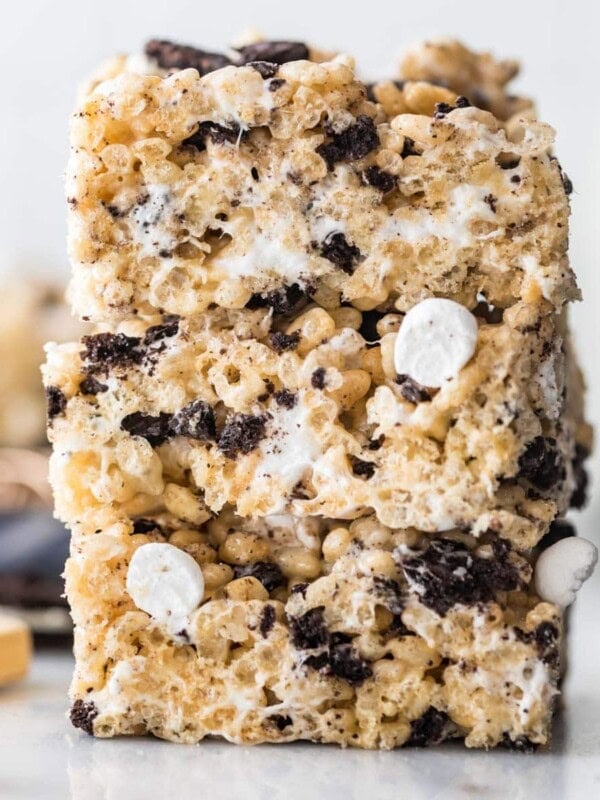 three stacked cookies and cream rice krispie treats studded with crushed oreos and mini marshmallows