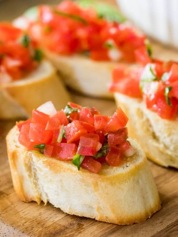 slices of bruschetta topped with chopped marinated tomatoes, basil, and garlic