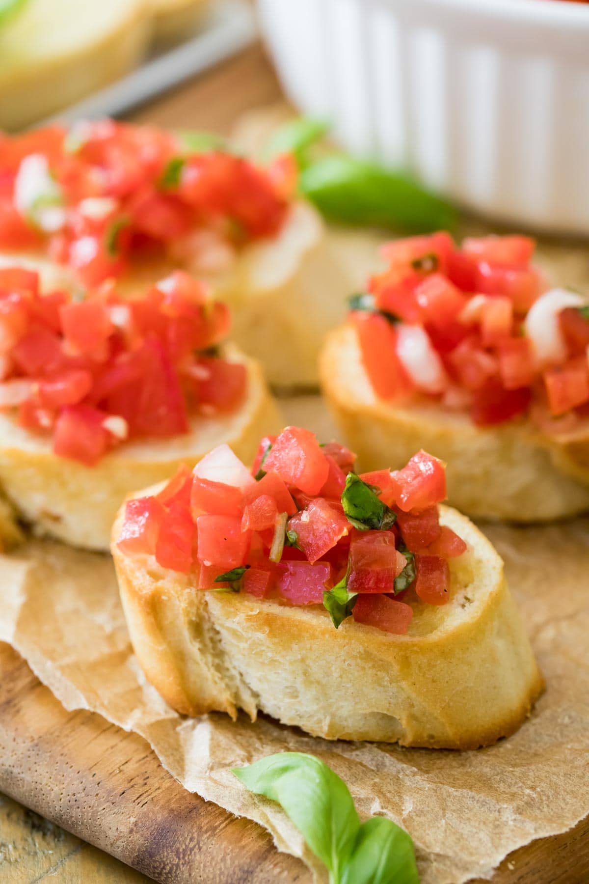 toasted slices of french baguette topped with chopped marinated tomatoes, basil, and garlic