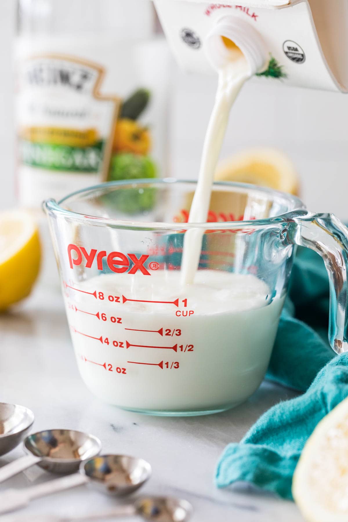 milk being poured into a liquid measuring cup
