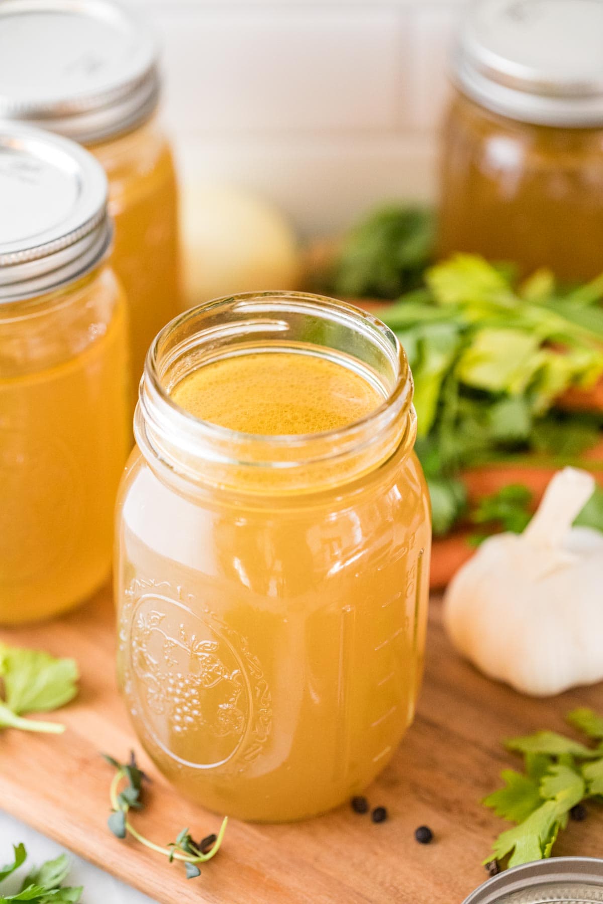 mason jar of chicken broth made from a homemade chicken stock recipe