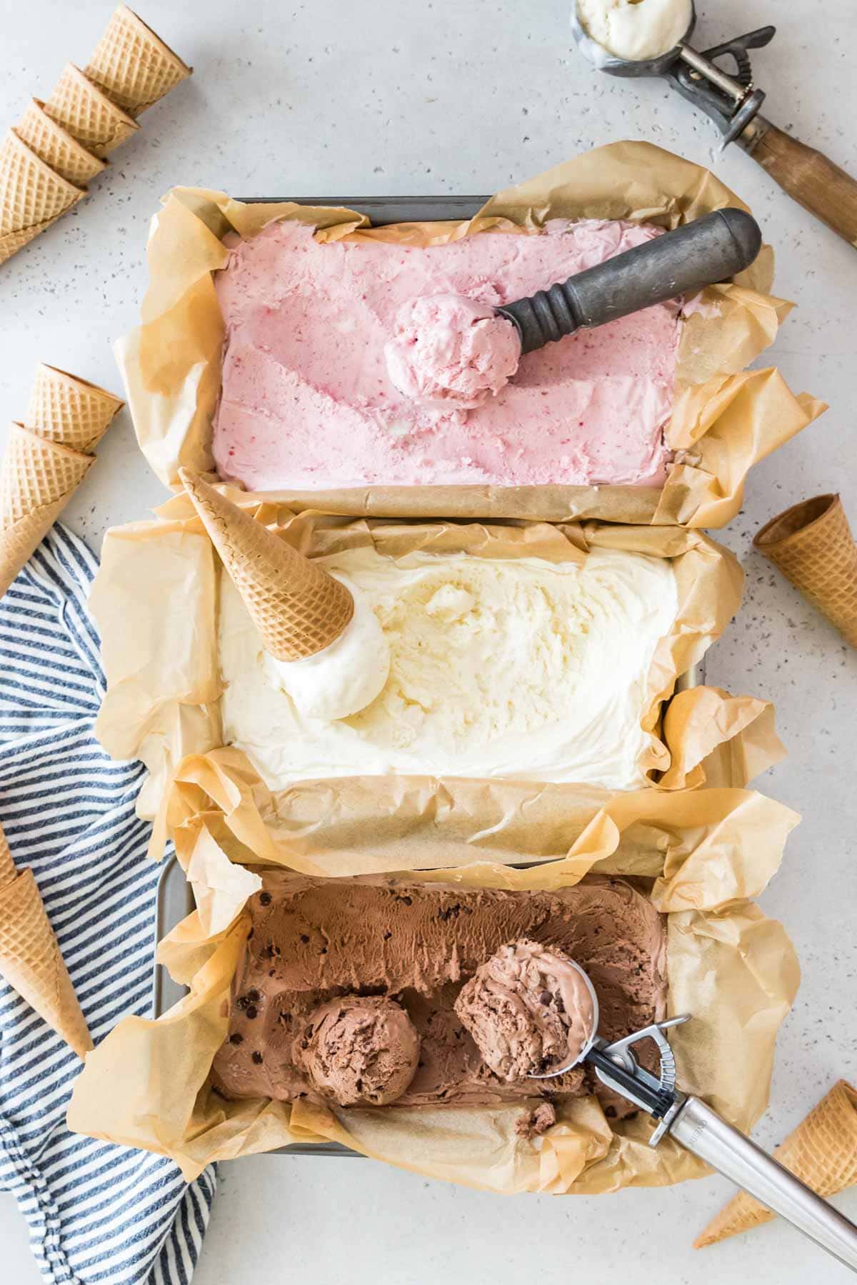 overhead view of three flavors of no churn ice cream including strawberry, vanilla, and chocolate