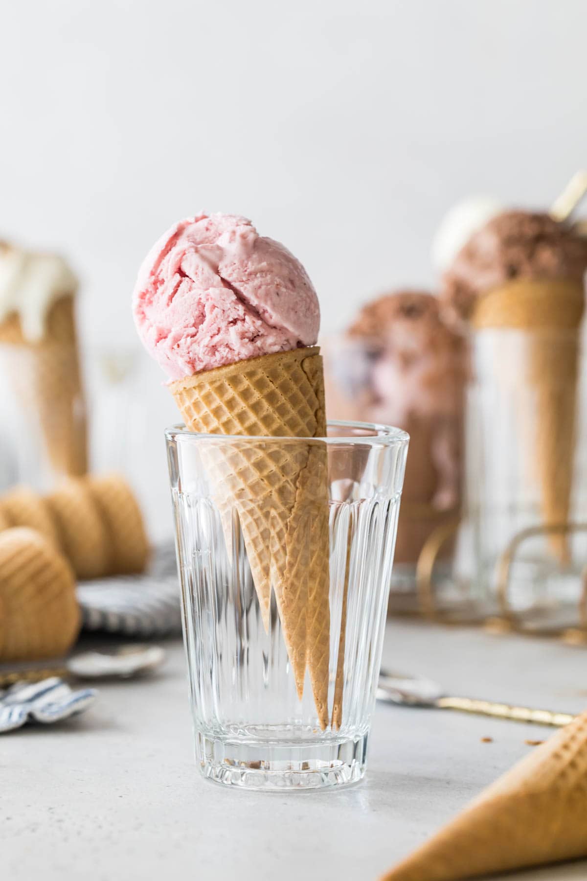 strawberry ice cream cone standing in a clear drinking glass