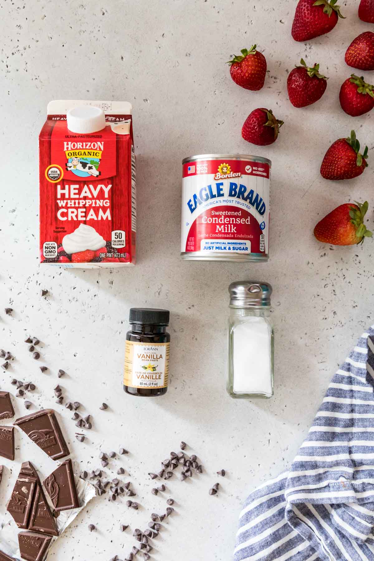 overhead view of ingredients including heavy cream, sweetened condensed milk, vanilla, and salt