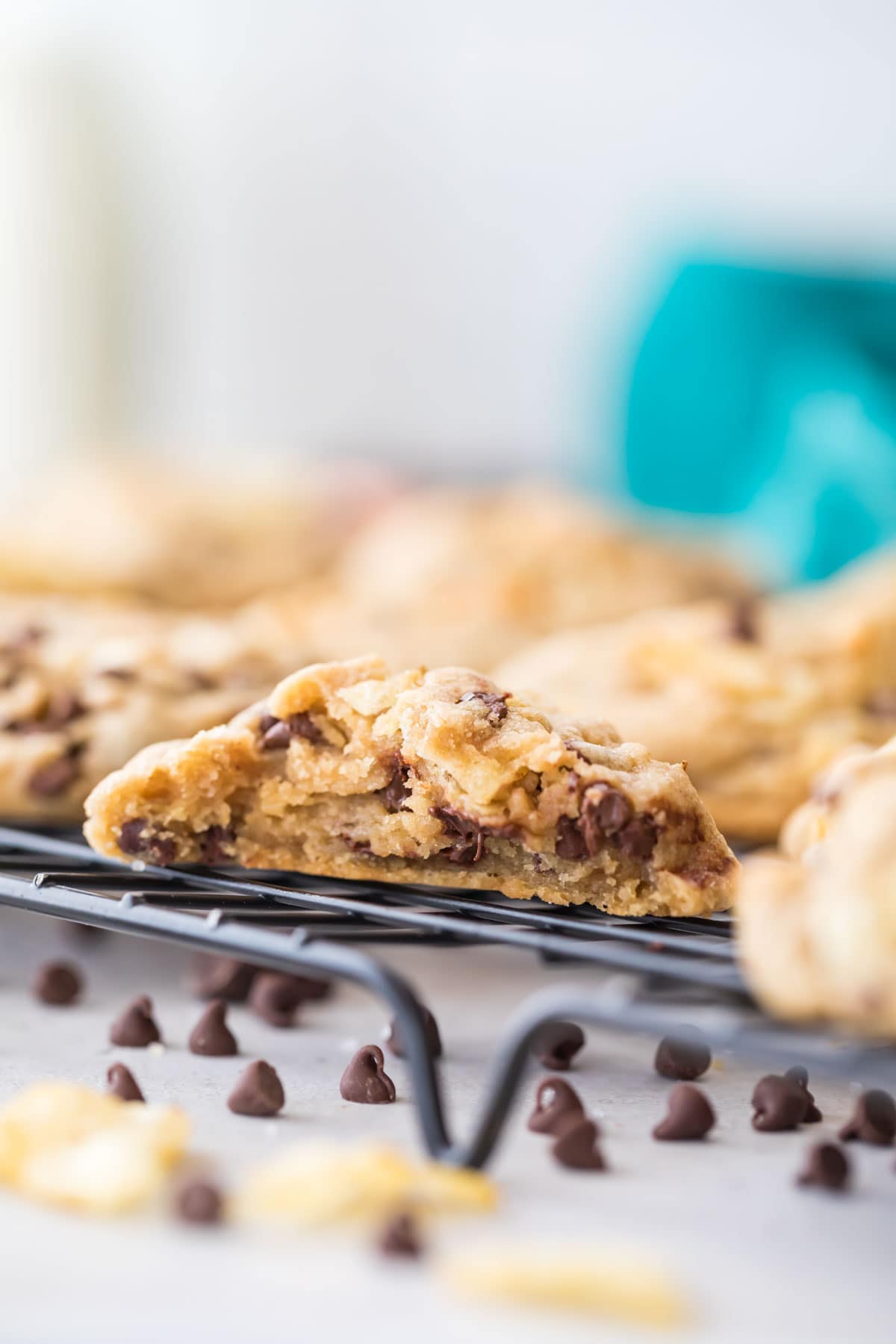 cross section of a chocolate chip cookie resting on a cooling rack