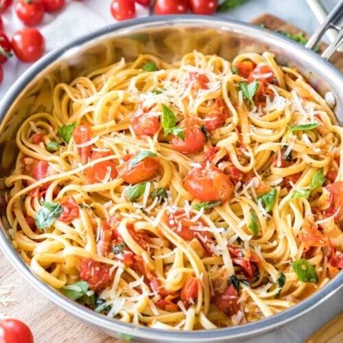 summer pasta with fresh cherry tomatoes and basil served in a skillet