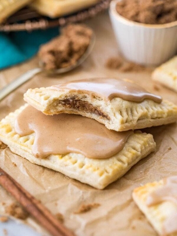 two homemade pop tarts stacked on top of each other, with the top pop tart missing a bite