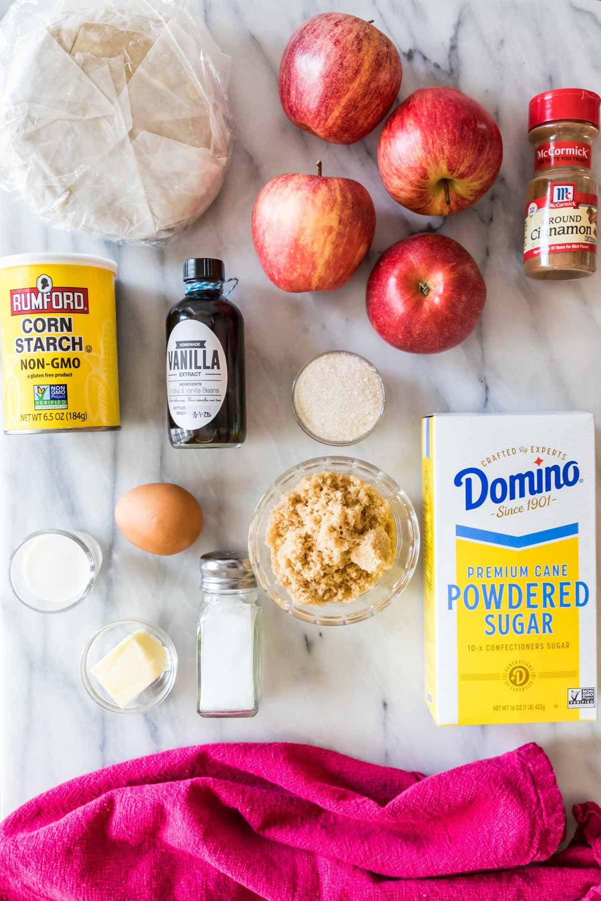 overhead view of ingredients including pie dough, apples, cinnamon and more