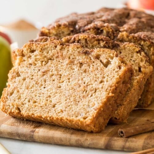 stacked slices of apple bread resting against the remaining loaf