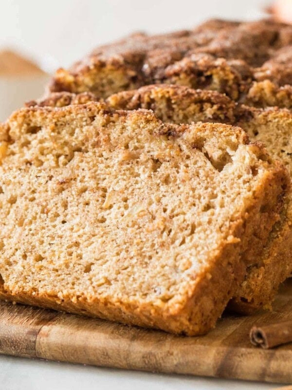 stacked slices of apple bread resting against the remaining loaf