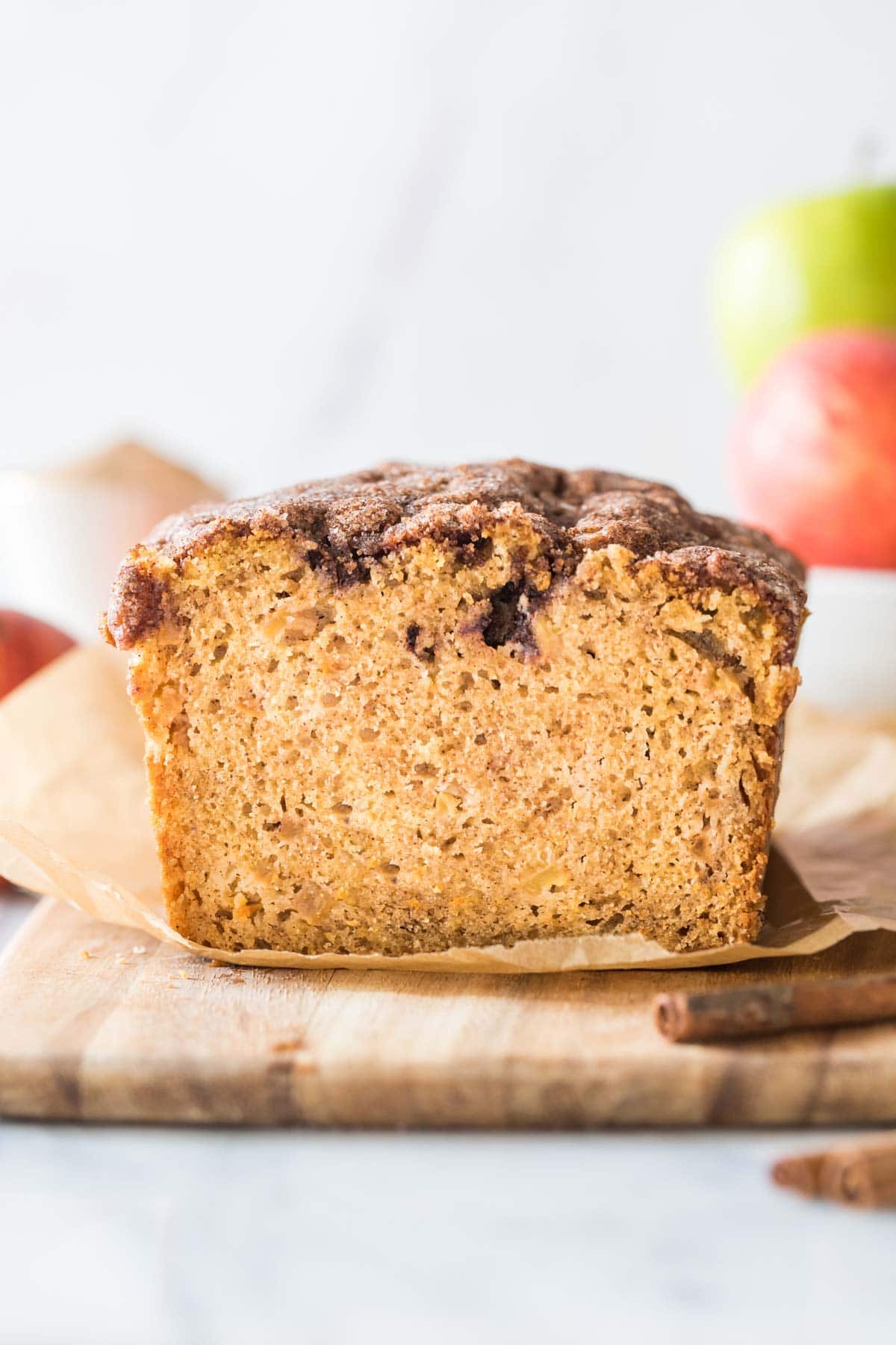 head-on view of a loaf of apple bread that's been sliced to show its texture