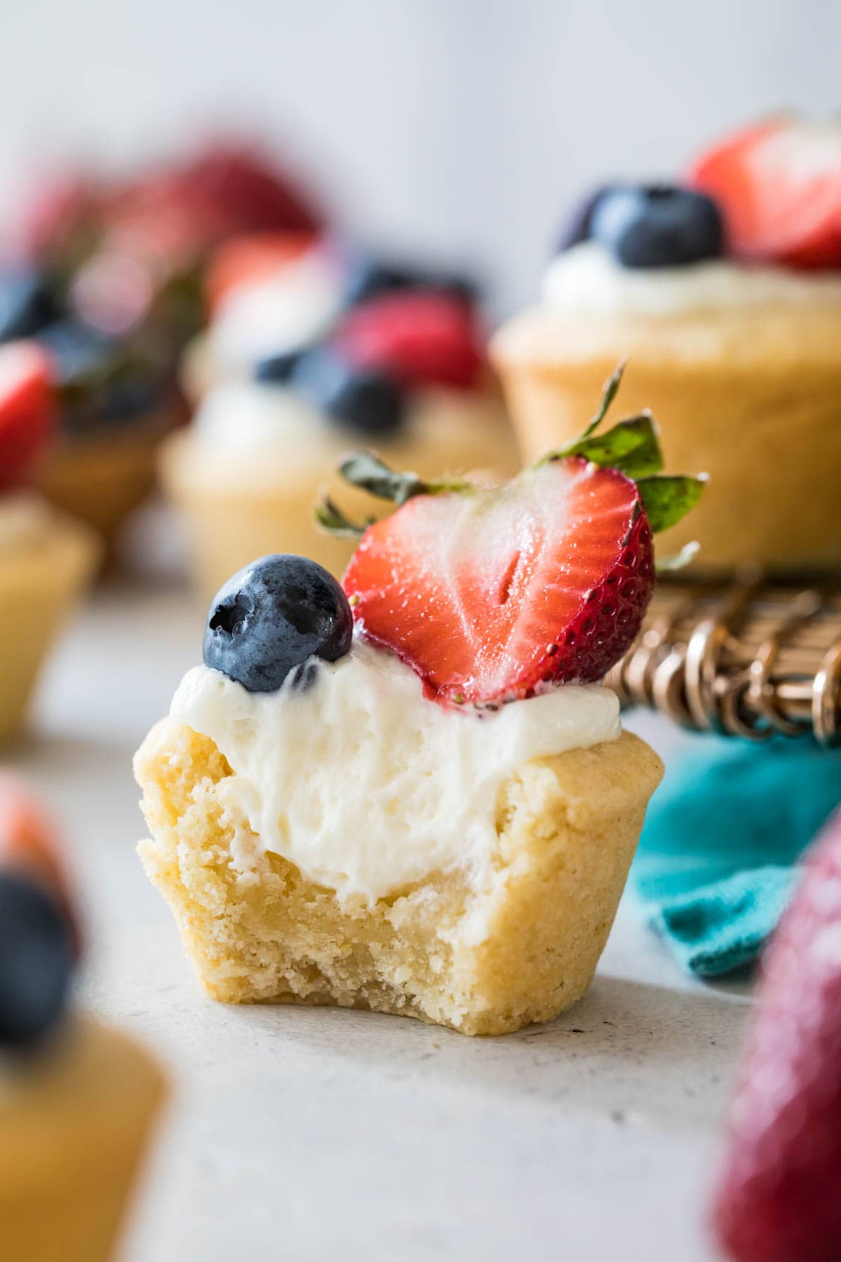 bite-sized cheesecake stuffed sugar cookie cup that's been bitten into