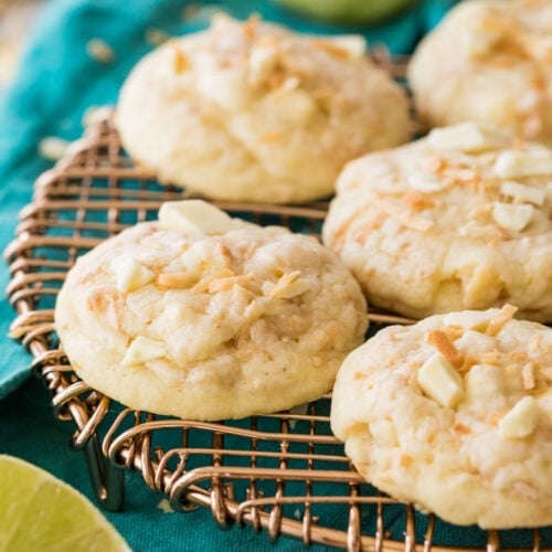 Island cookies topped with coconut and white chocolate chunks resting on a metal cooling rack
