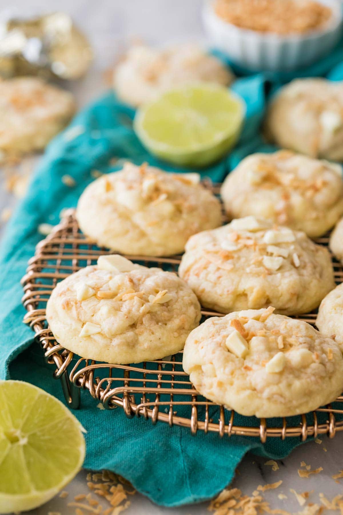 Island cookies topped with coconut and white chocolate chunks resting on a metal cooling rack