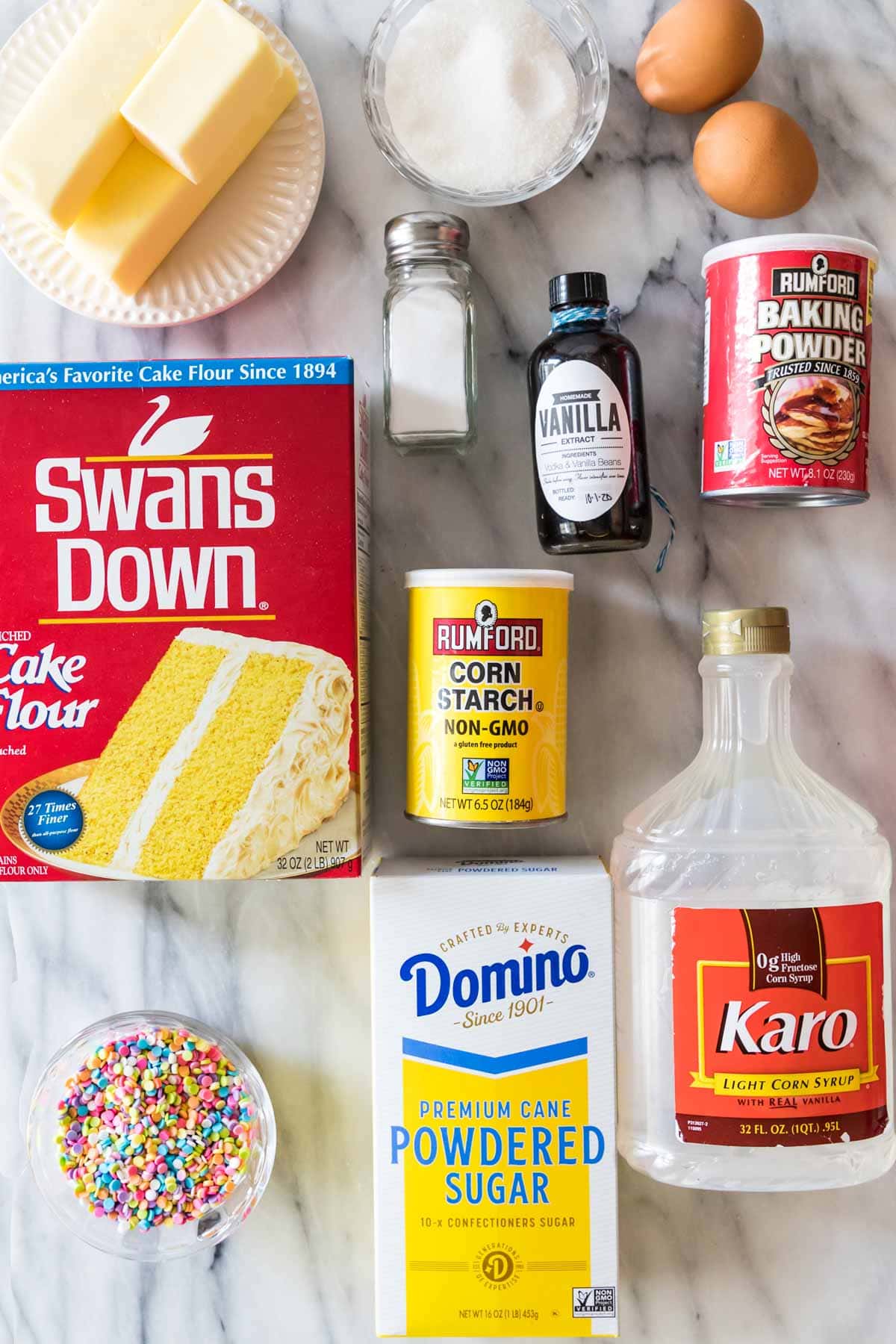 overhead view of ingredients including cake flour, butter, vanilla, corn syrup, and more