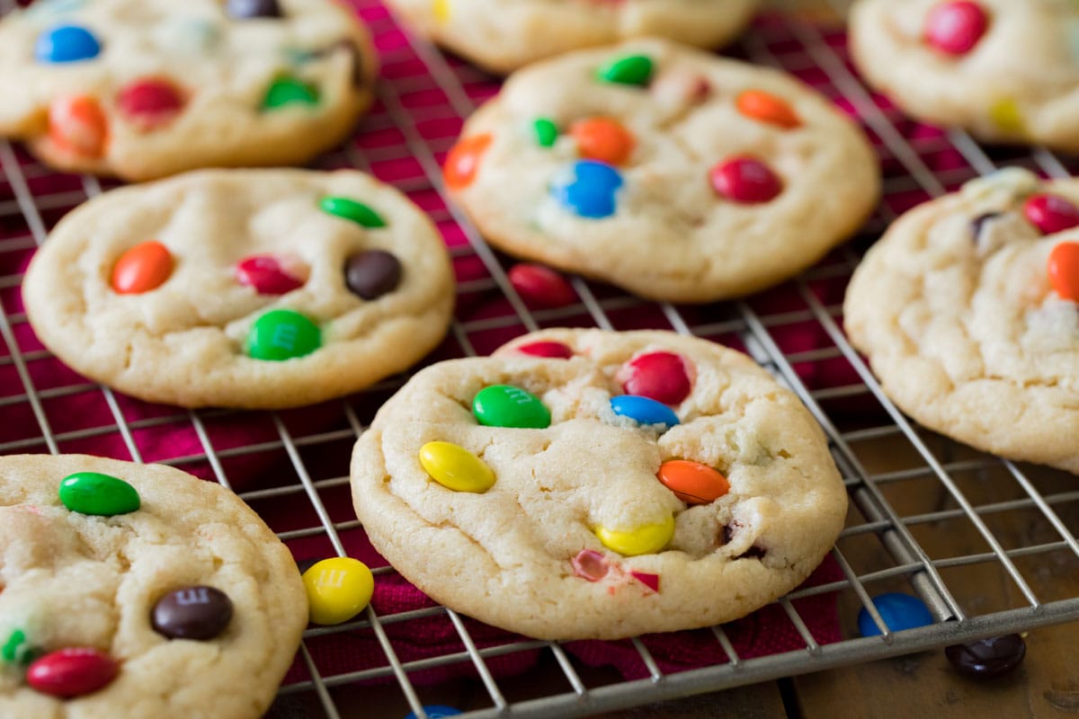 cookies made with m&m candies on a cooling rack after baking