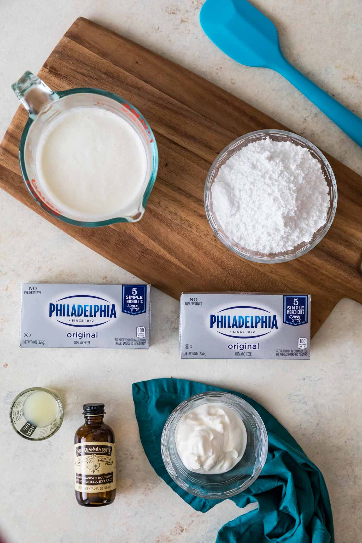 overhead view of ingredients including cream cheese, powdered sugar, sour cream, and more