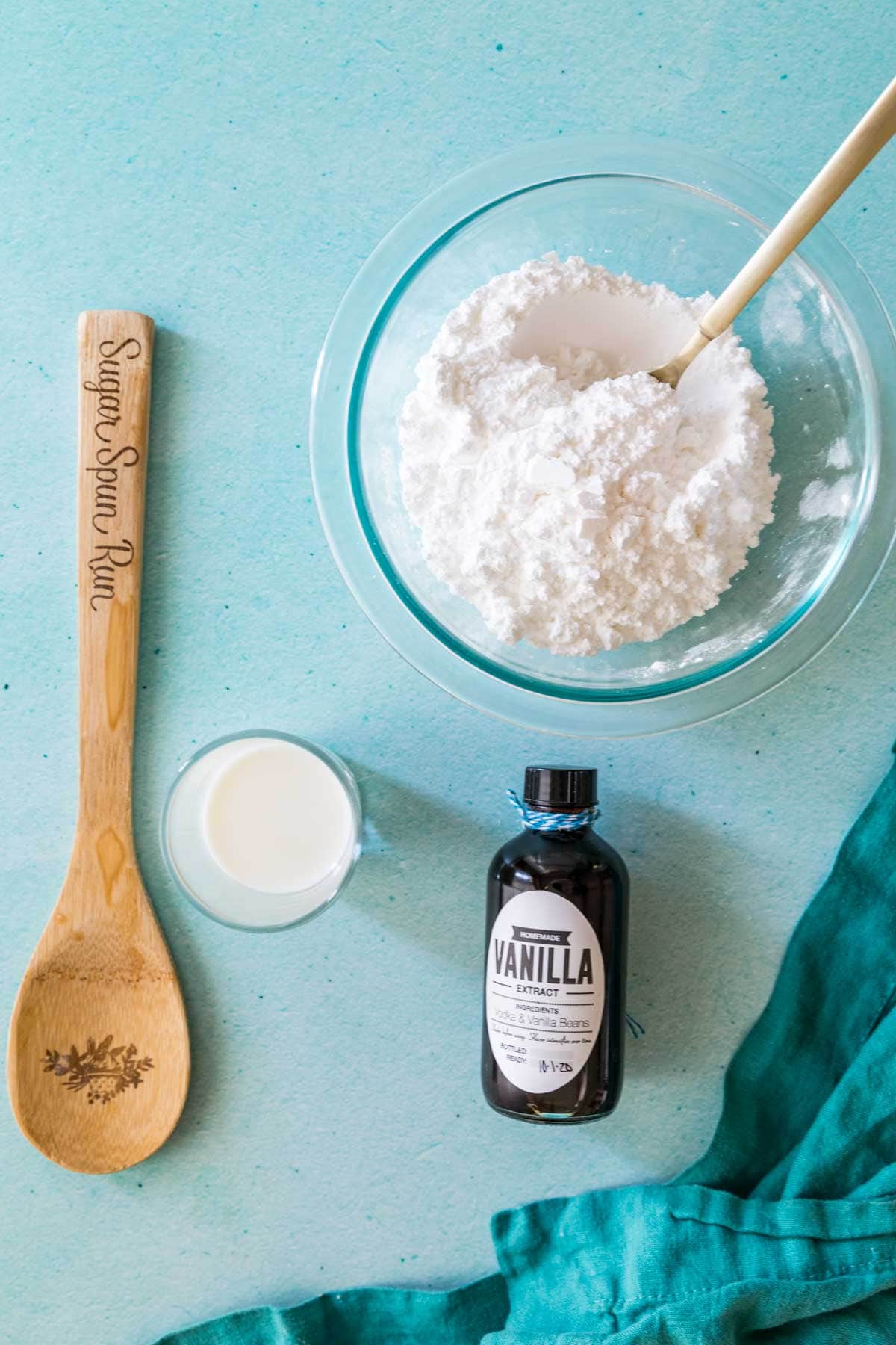 overhead view of ingredients including powdered sugar, milk, and vanilla