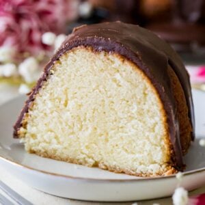 slice of hot milk cake topped with a fudgy chocolate frosting